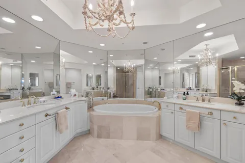 a large white kitchen with a sink and cabinets
