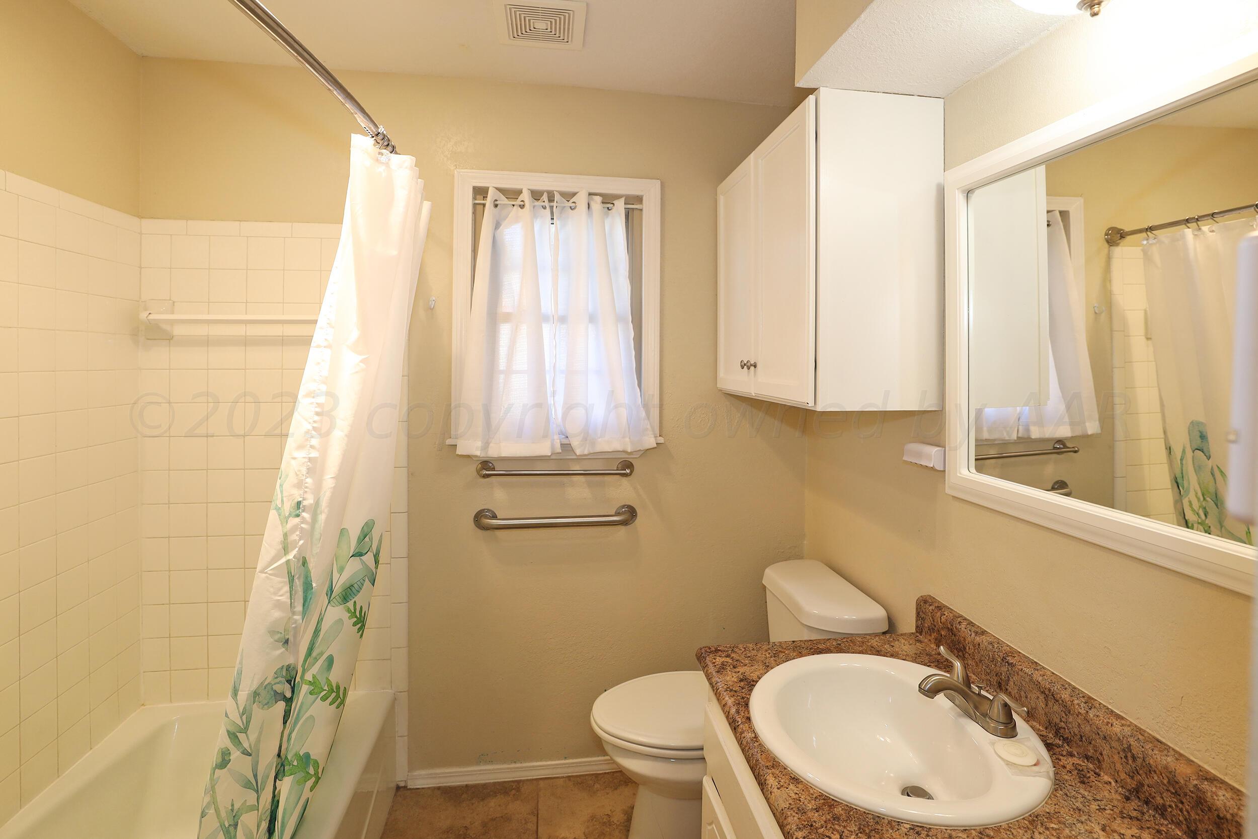 2905 Salem Drive Amarillo, TX 79110 - Photo 24 of 29 a bathroom with a sink a toilet and shower