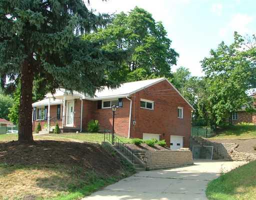2 Greenview Drive McKees Rocks, PA 15136 - Photo 1 of 10 Exterior Front. 2 Greenview sits on a corner lot with wide driveway and two garages with integral parkinf for 3 cars.