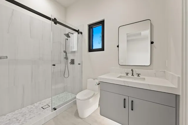 a bathroom with a shower and a sink
