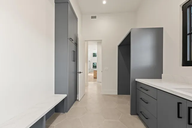 a view of a kitchen with refrigerator and mirror