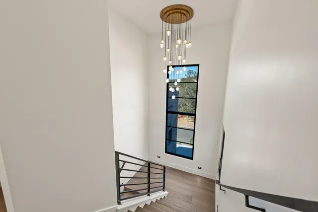 a spacious bedroom with a bed a mirror and dresser