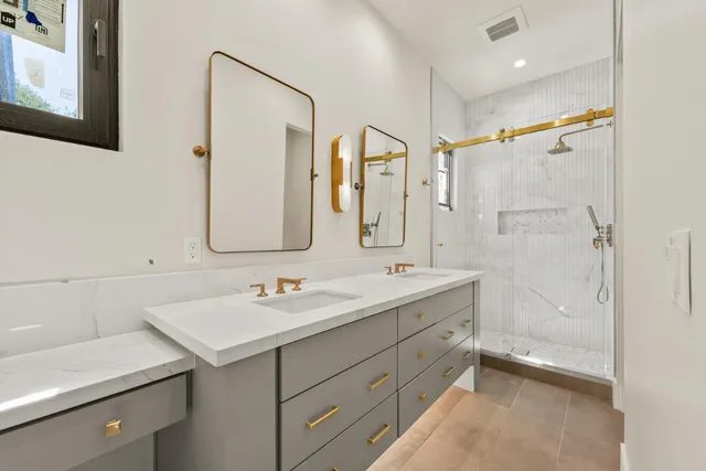 a spacious bedroom with a bed and a large window