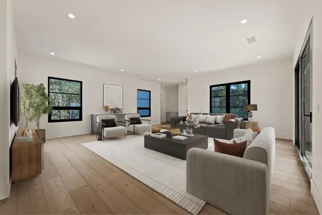 a bathroom with a double vanity sink mirror and toilet