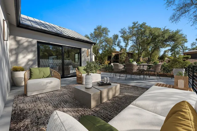 a view of a patio with table and chairs