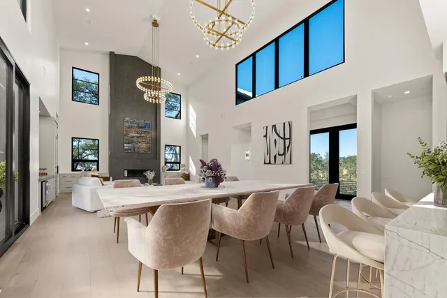 a large white kitchen with a large window and stainless steel appliances