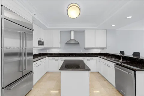 a kitchen with granite countertop a sink and a stove