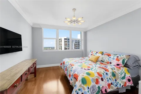 a bedroom with a bed and a flat screen tv