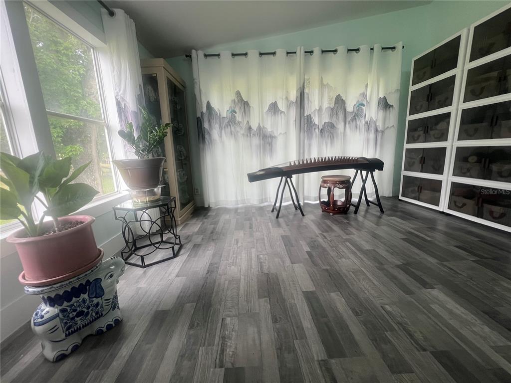 5855 Jack Brack Road St. Cloud, FL 34771 - Photo 16 of 86 a living room with furniture and a wooden floor