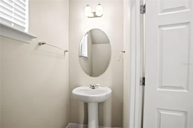 a bathroom with a sink a mirror and a toilet