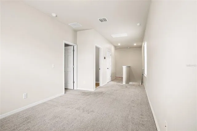 a view of a big room with closet and windows