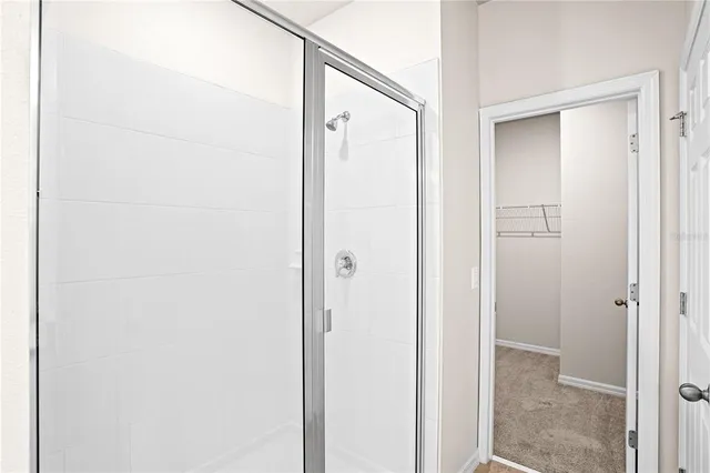 a bathroom with a glass shower door