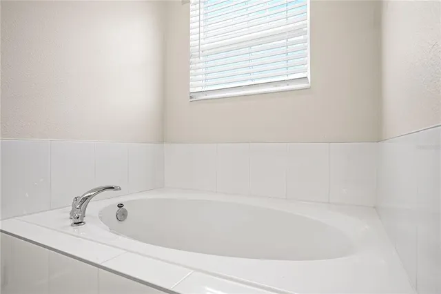 a white bath tub sitting next to a window