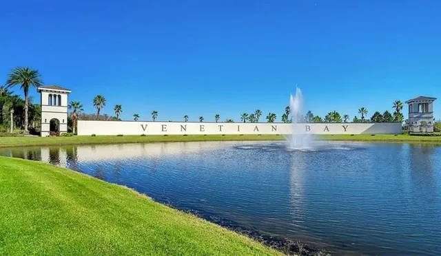 a view of a lake with houses in the background