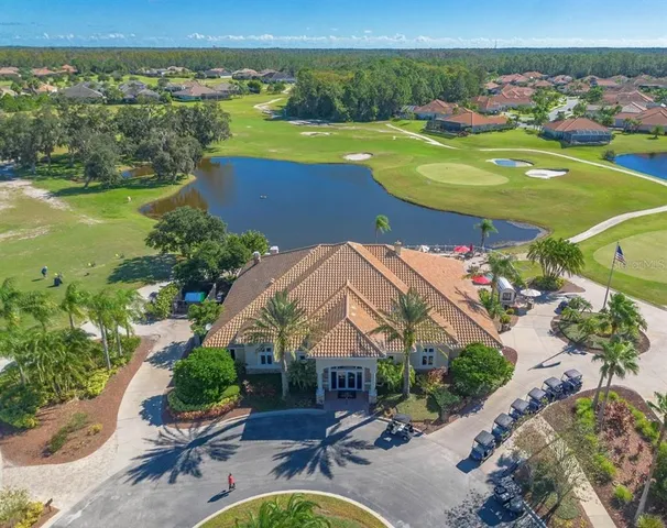 an aerial view of a house with a garden and lake view