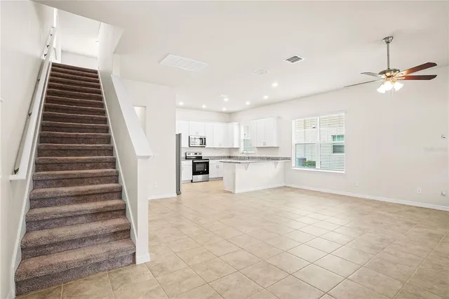 a view of kitchen with sink and refrigerator