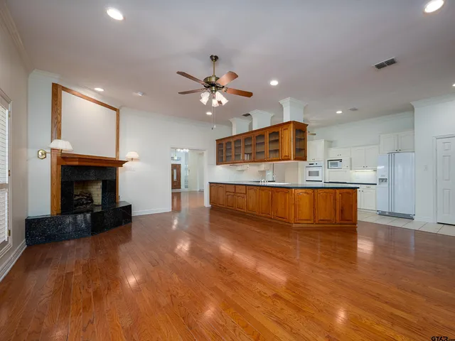a view of kitchen with cabinets and fireplace