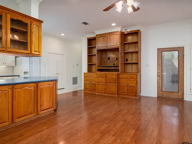 a kitchen with stainless steel appliances a refrigerator and wooden floor