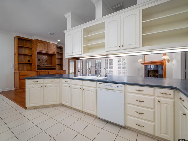 a kitchen with granite countertop white cabinets and white stainless steel appliances