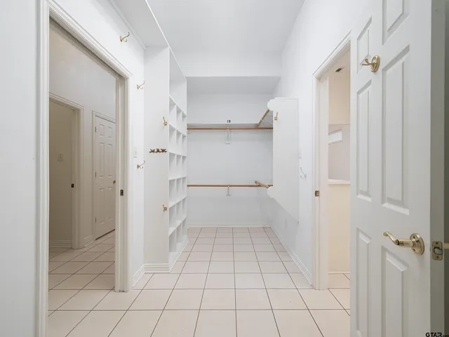 a view of walk in closet with white walls