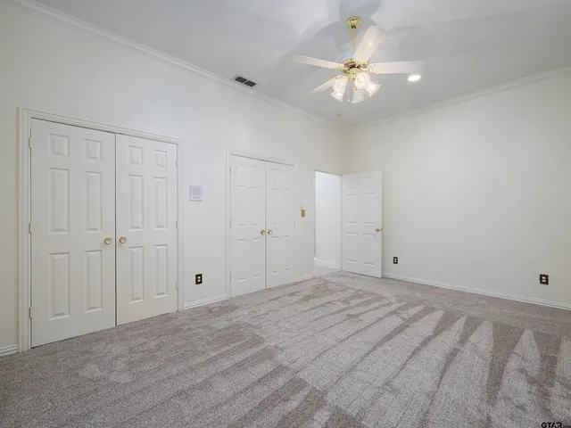 a view of a room with a ceiling fan