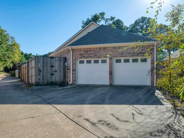 a front view of house with wooden fence