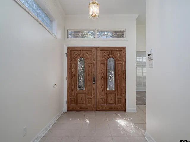 a view of front door with chandelier