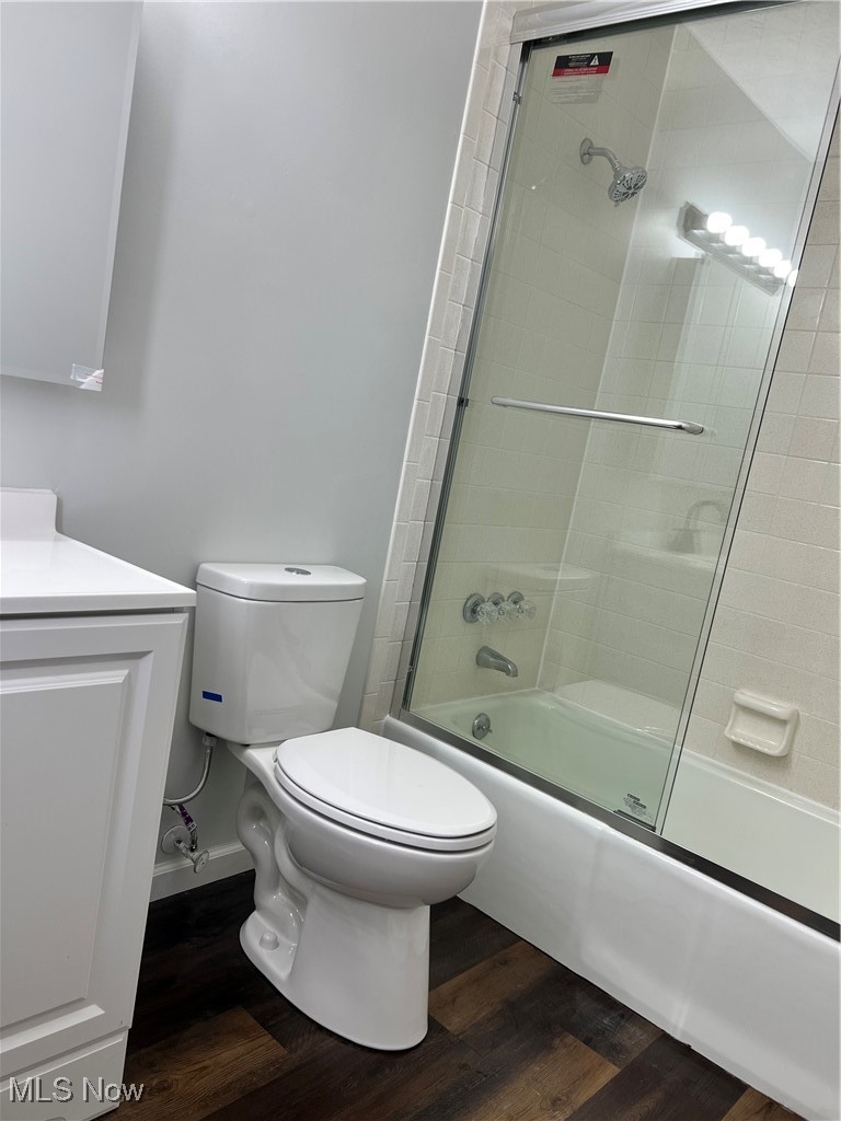 15317 Strader Road East Liverpool, OH 43920 - Photo 17 of 23 Full bathroom with hardwood / wood-style floors, toilet, combined bath / shower with glass door, and vanity