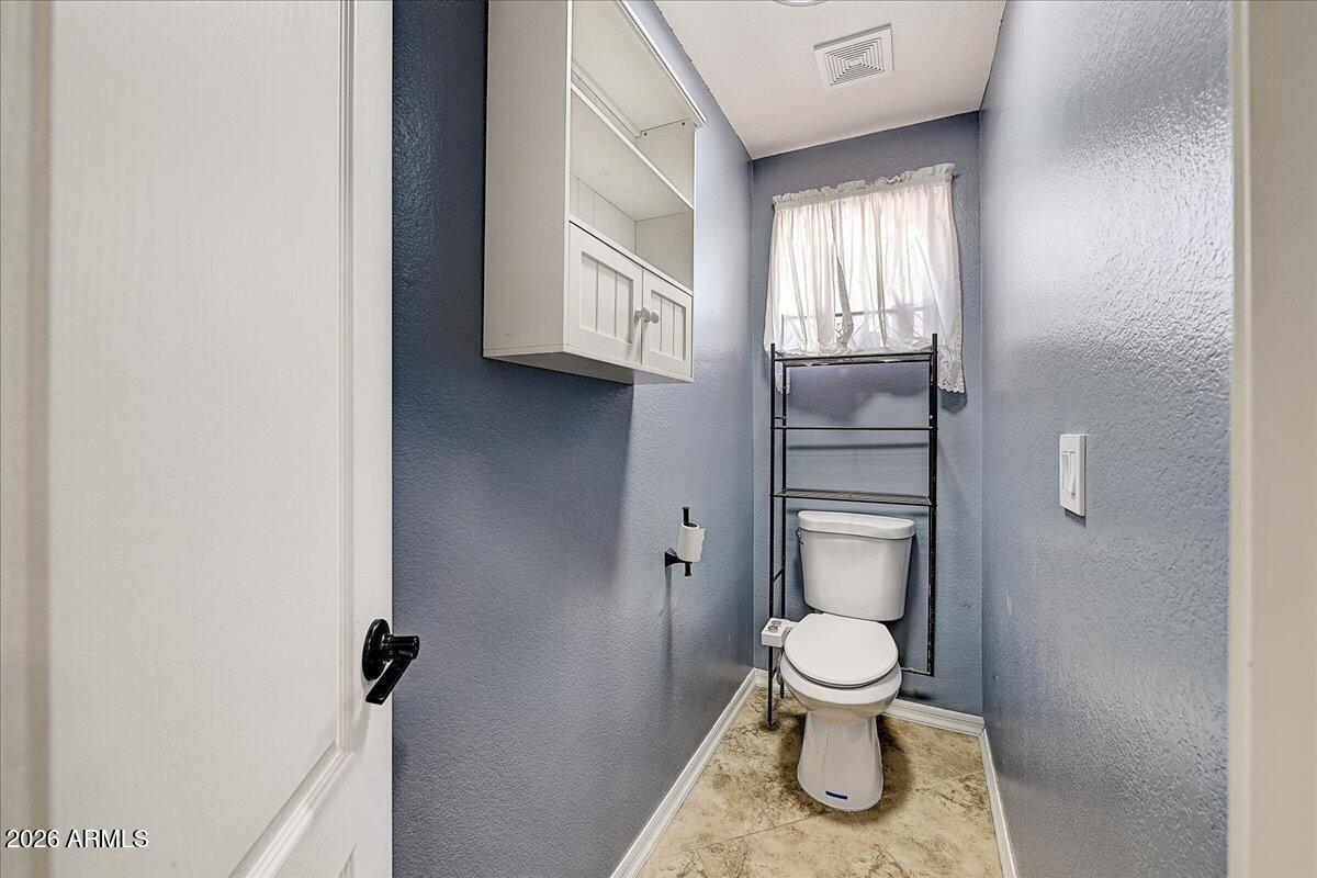7624 North Citrus Road Waddell, AZ 85355 - Photo 24 of 57 a bathroom with a toilet and a sink