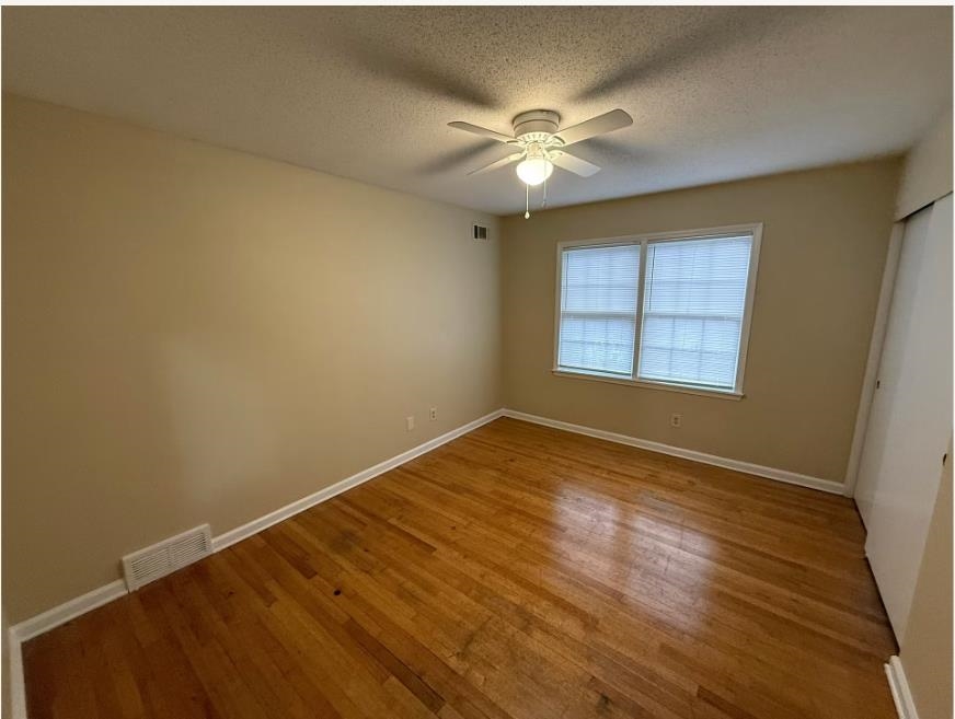 5355 Rock Ridge Road South Memphis, TN 38134 - Photo 6 of 12 an empty room with wooden floor fan and windows