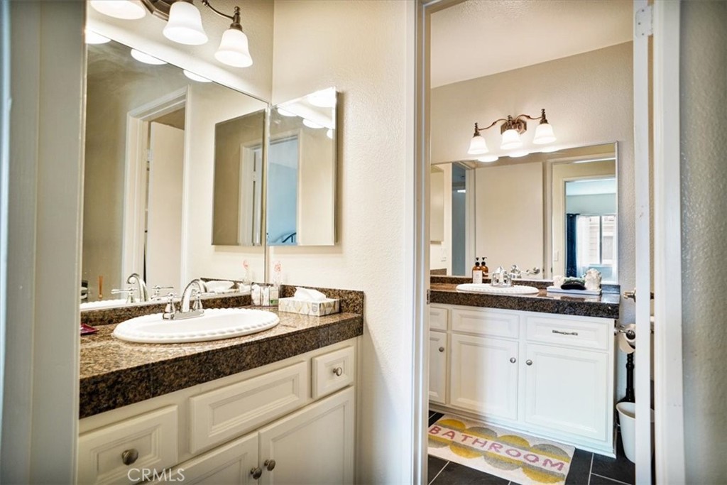 31311 The Old Road, Unit E Castaic, CA 91384 - Photo 11 of 19 a bathroom with a sink and a mirror