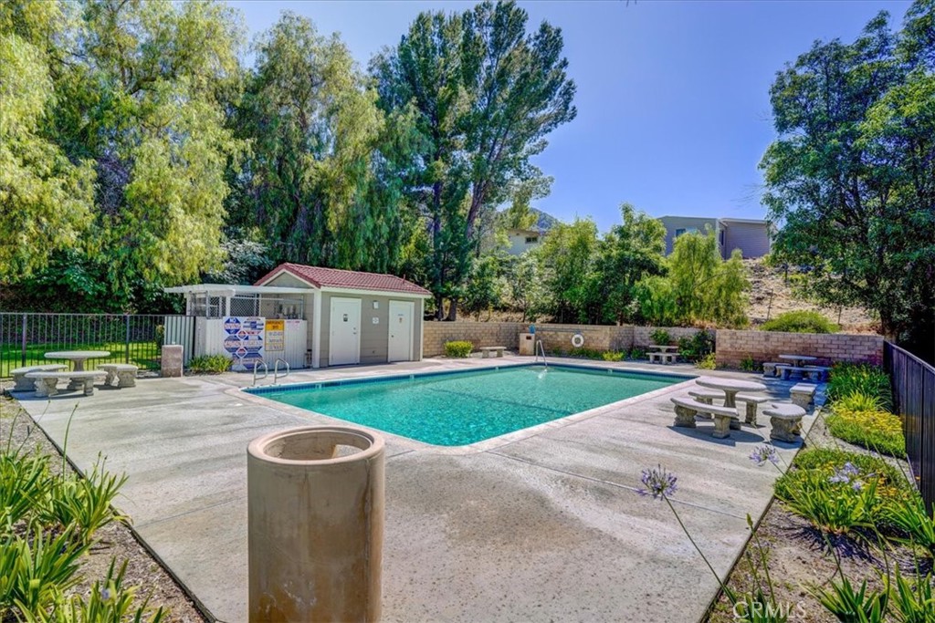 31311 The Old Road, Unit E Castaic, CA 91384 - Photo 14 of 19 a front view of a house with garden