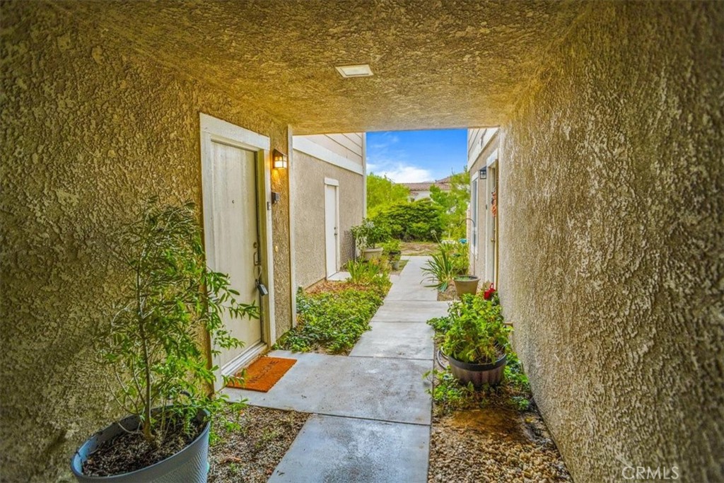 31311 The Old Road, Unit E Castaic, CA 91384 - Photo 3 of 19 a view of a pathway with flower plants