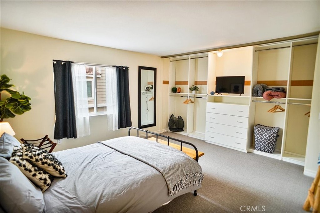 31311 The Old Road, Unit E Castaic, CA 91384 - Photo 8 of 19 a bedroom with a bed next to a large window with the outer view