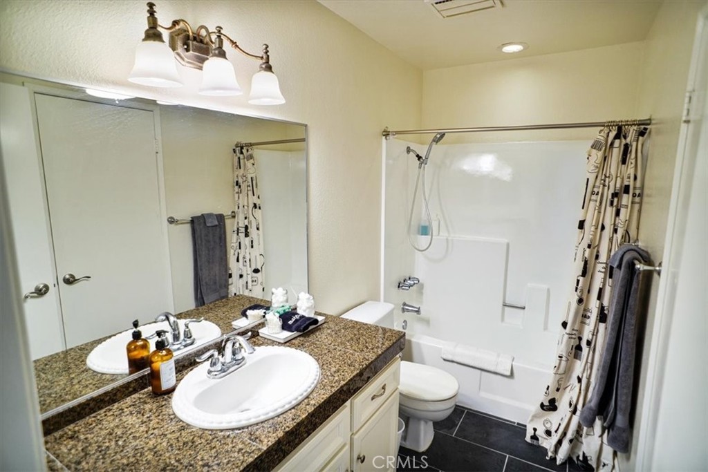 31311 The Old Road, Unit E Castaic, CA 91384 - Photo 10 of 19 a bathroom with a granite countertop sink toilet and shower