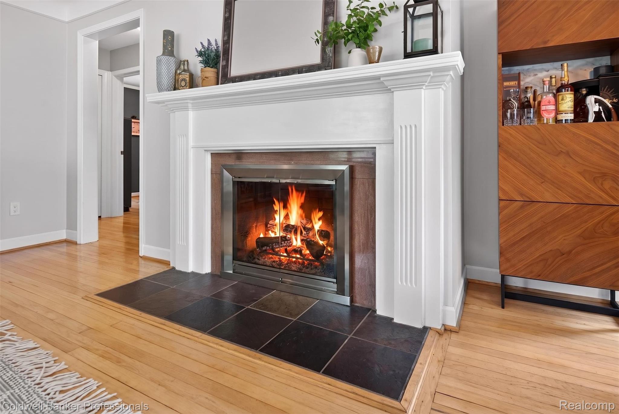 2666 Windemere Road Birmingham, MI 48009 - Photo 4 of 24 Fireplace with white wood mantel and dark tile hearth, set against light gray walls