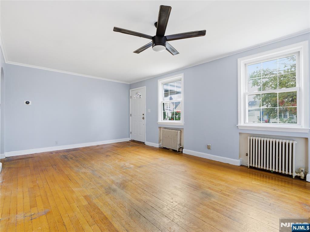 153 Arlington Avenue Paterson, NJ 07502 - Photo 3 of 12 a view of room with a ceiling fan and window