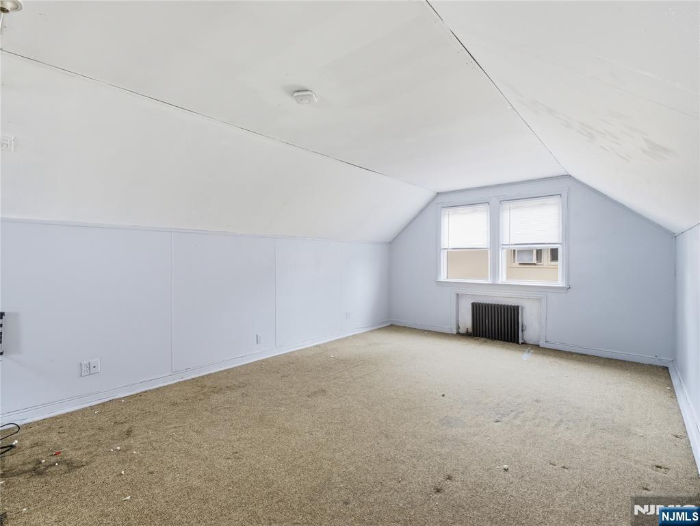 153 Arlington Avenue Paterson, NJ 07502 - Photo 7 of 12 an empty room with windows