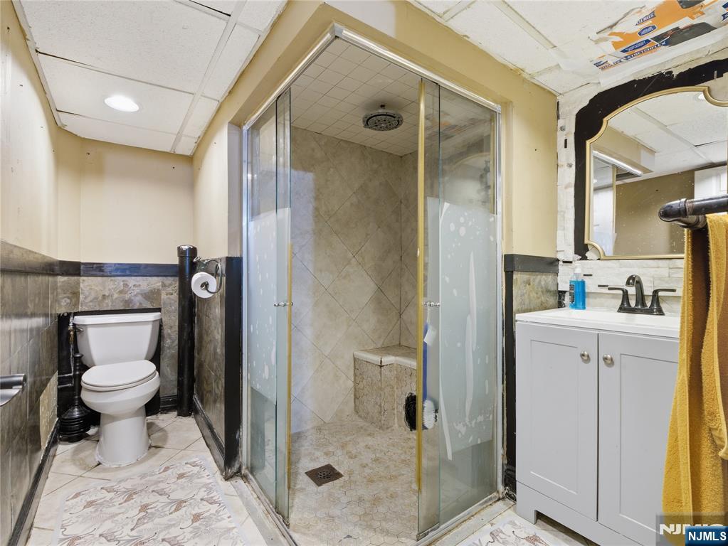 153 Arlington Avenue Paterson, NJ 07502 - Photo 9 of 12 a bathroom with a sink toilet and shower