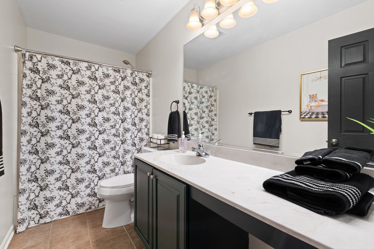 2561 Hennig Road Hampshire, IL 60140 - Photo 13 of 36 a bathroom with a sink a toilet and a mirror