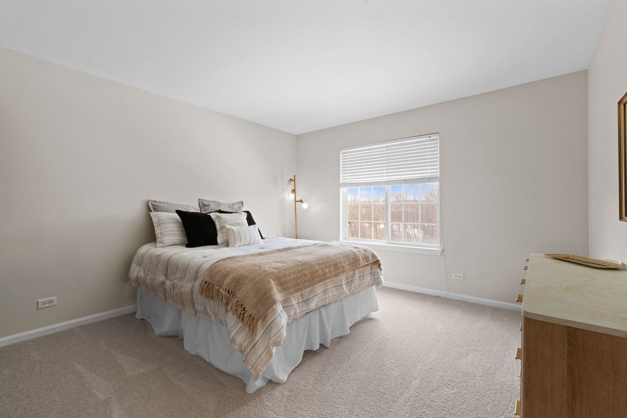 2561 Hennig Road Hampshire, IL 60140 - Photo 14 of 36 a spacious bedroom with a bed and window
