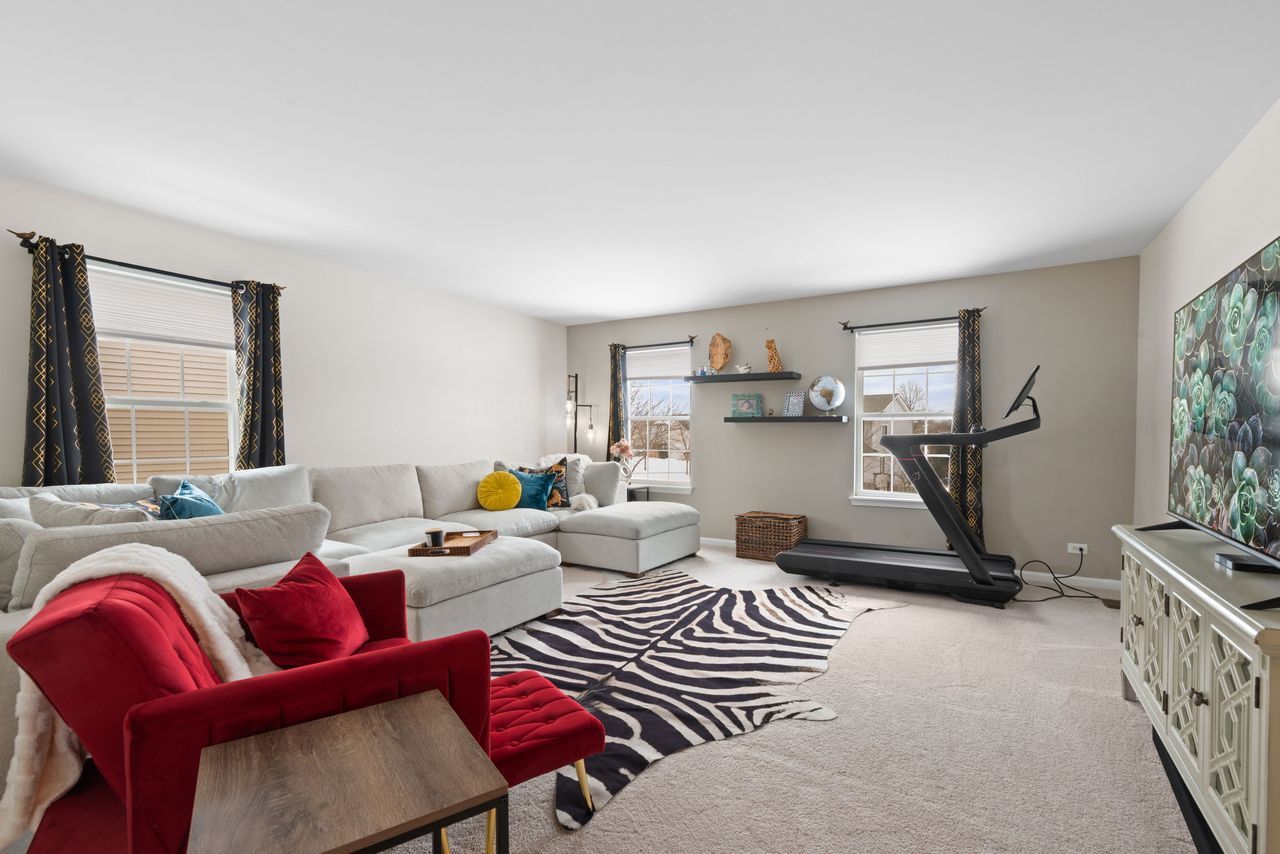 2561 Hennig Road Hampshire, IL 60140 - Photo 18 of 36 a living room with furniture a air conditioner vent and a window