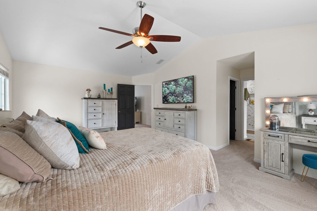 2561 Hennig Road Hampshire, IL 60140 - Photo 20 of 36 a bedroom with a bed and a chandelier