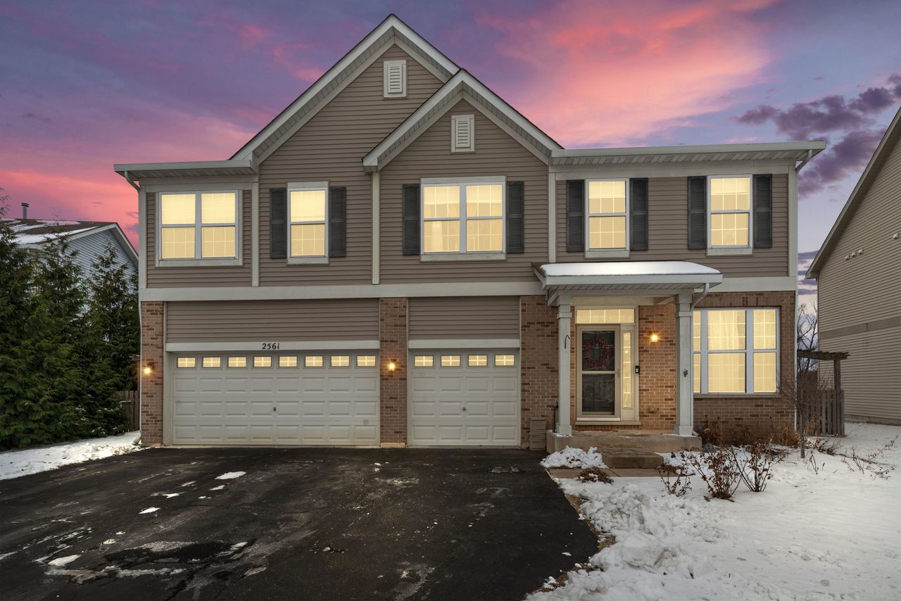 2561 Hennig Road Hampshire, IL 60140 - Photo 2 of 36 a front view of a house with a yard and garage