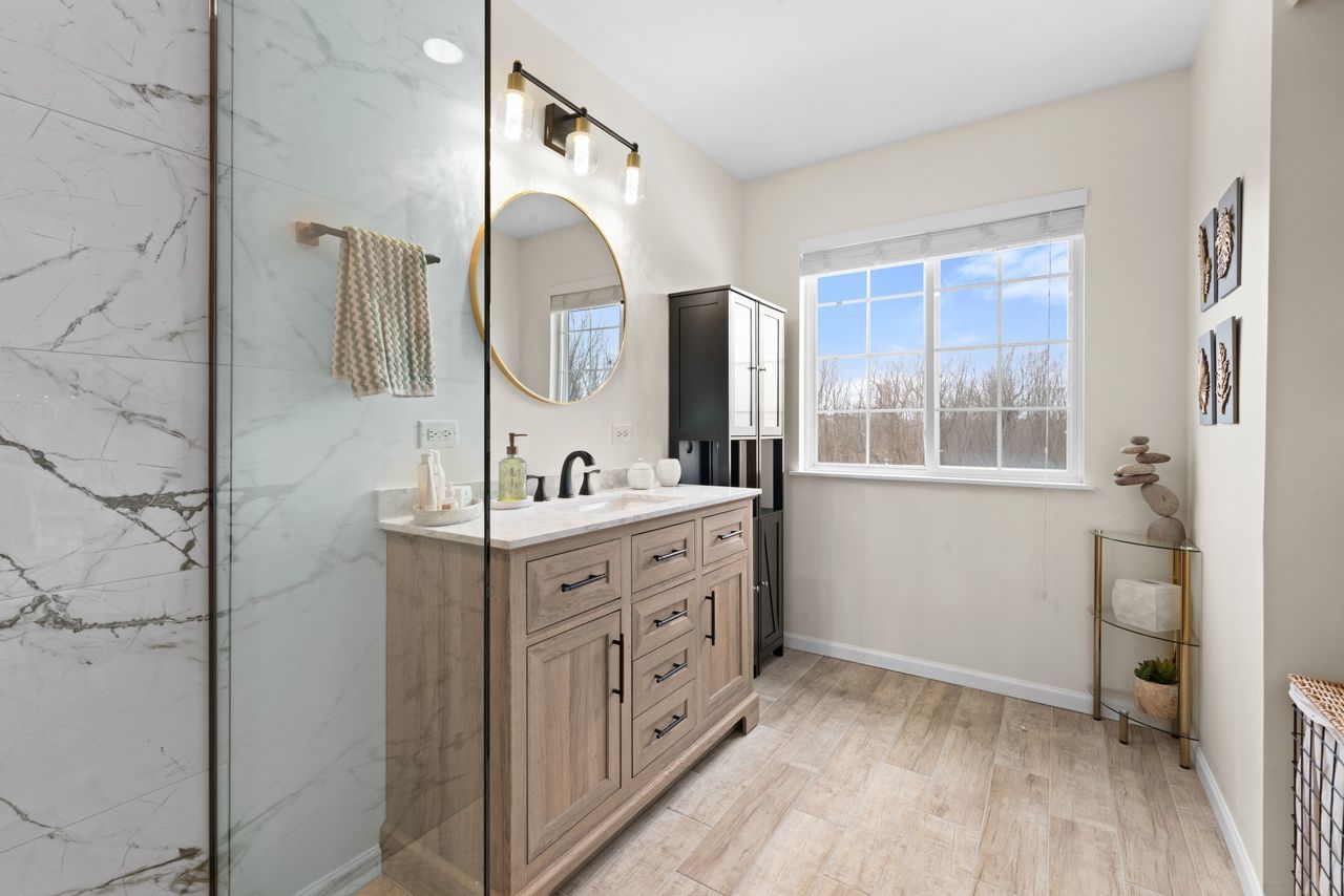 2561 Hennig Road Hampshire, IL 60140 - Photo 22 of 36 a spacious bathroom with a double vanity sink and a mirror