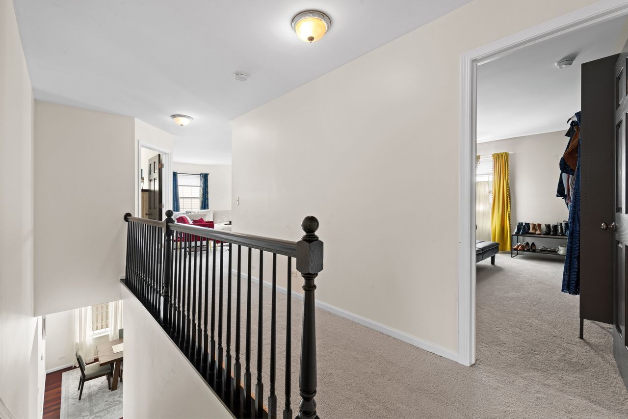 2561 Hennig Road Hampshire, IL 60140 - Photo 23 of 36 a view of a hallway to a livingroom and a hallway with furniture and a window