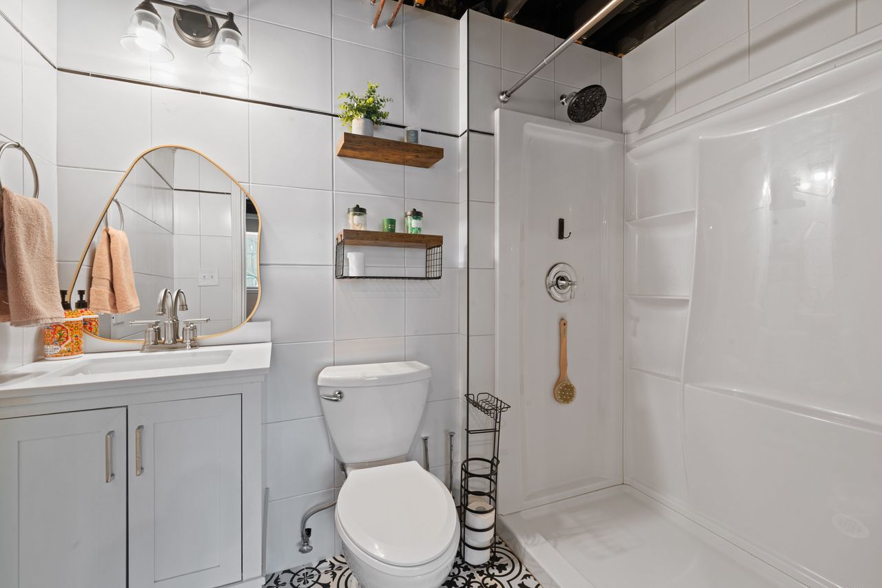 2561 Hennig Road Hampshire, IL 60140 - Photo 27 of 36 a bathroom with a toilet sink and shower