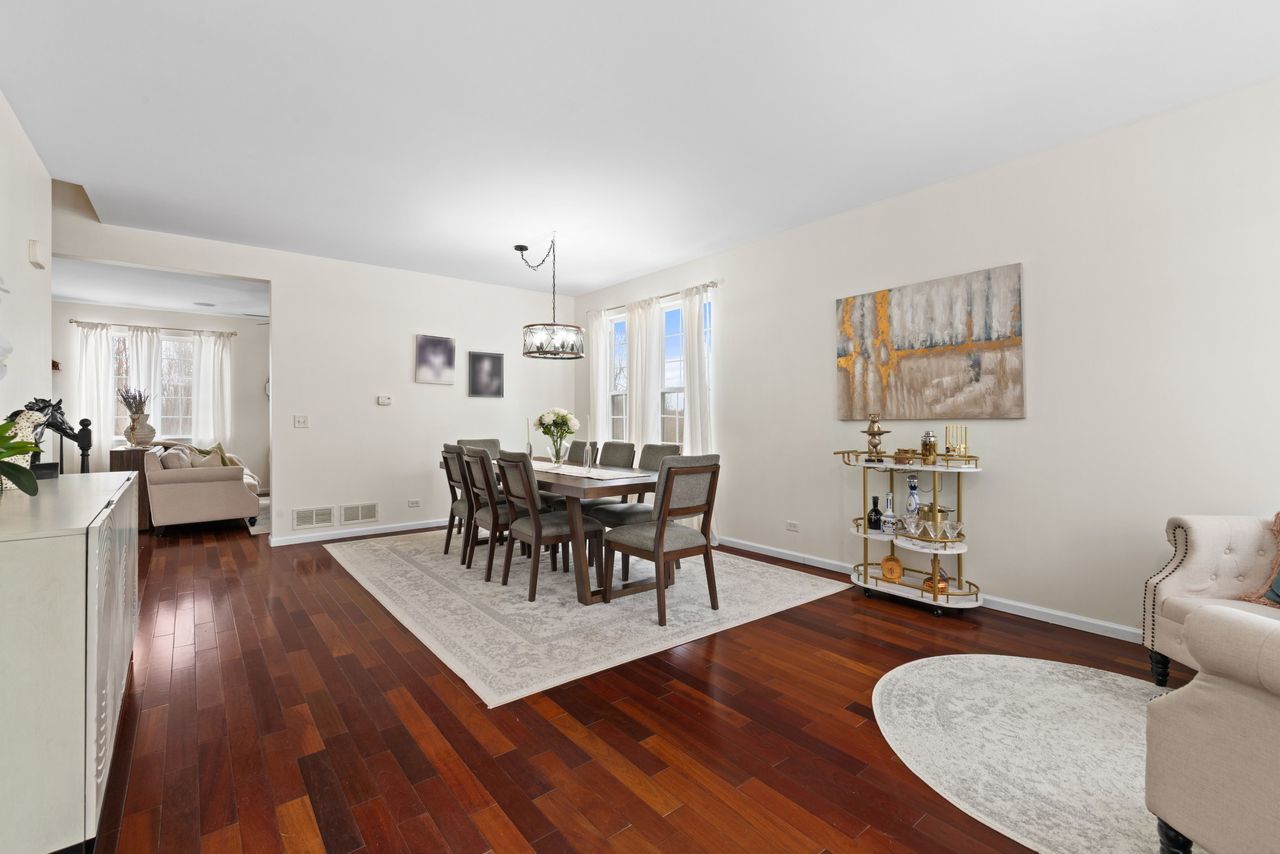 2561 Hennig Road Hampshire, IL 60140 - Photo 3 of 36 a view of a dining room with furniture and wooden floor