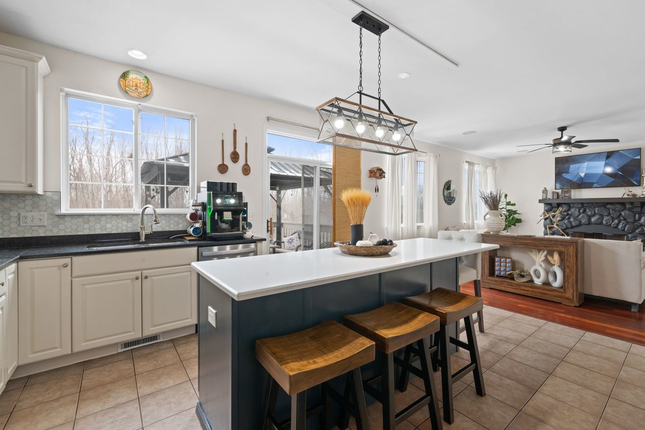 2561 Hennig Road Hampshire, IL 60140 - Photo 10 of 36 a kitchen with a dining table chairs sink and stove