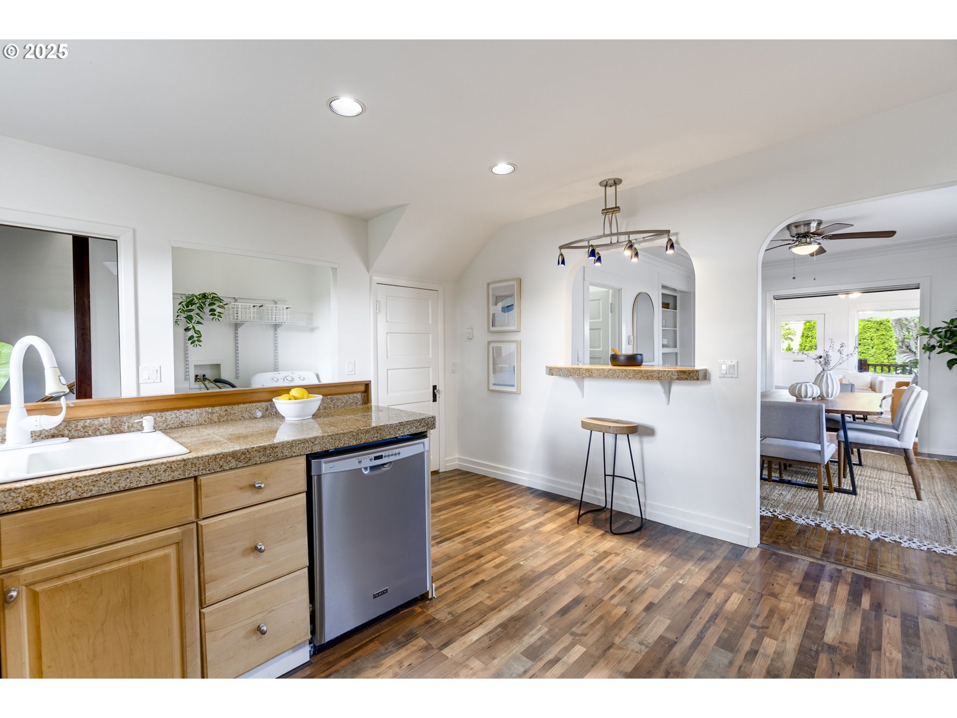 6020 Southeast 83rd Avenue Portland, OR 97266 - Photo 14 of 46 a kitchen with granite countertop a sink cabinets and wooden floor